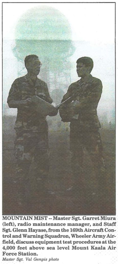 MOUNTAIN MIST-- Master Sgt. Garret Miura (left), radio maintenance manager, and Staff Sgt. Glenn Hayase, from the 169th Aircraft Control and Warning Squadron, Wheeler Army Airfield, discuss equipment test procedures at the 4,000 feet above sea level Mount Kaala Air Force Station. Master Sgt. Val Gempis photo