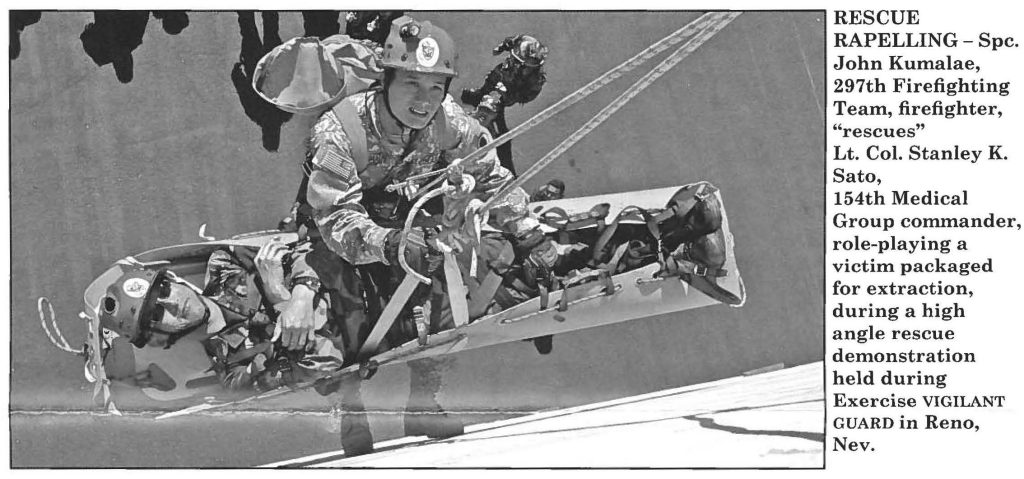 RESCUE RAPELLING - Spc. John Kumalae, 297th Firefighting Team, firefighter, "rescues" Lt. Col. Stanley K. Sato, 154th Medical Group commander, role-playing a victim packaged for extraction, during a high angle rescue demonstration held during Exercise VIGILANT GUARD in Reno, Nev.