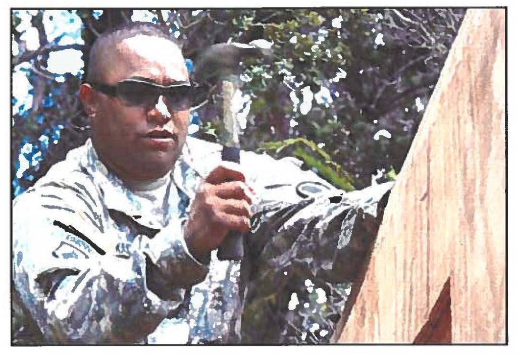 HAMMER TIME - Spc. Andrew P. Kalaukoa, a carpenter from Makaha, builds the outhouse roof.