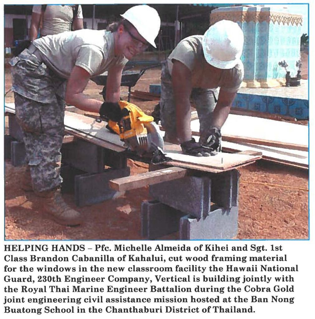 HELPING HANDS - Pfc. Michelle Almeida of Kihei and Sgt. 1st Class Brandon Cabanilla of Kahalui, cut wood framing material for the windows in the new classroom facility the Hawaii National Guard, 230th Engineer Company, Vertical is building jointly with the Royal Thai Marine Engineer Battalion during the Cobra Gold joint engineering civil assistance mission hosted at the Ban Nong Buatong School in the Chanthaburi District of Thailand.