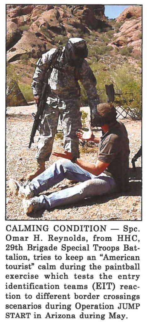 CALMING CONDITION - Spc. Omar H. Reynolds, from HHC, 29th Brigade Special Troops Battalion, tries to keep an "American tourist" calm during the paintball exercise which tests the entry identification teams (EIT) reaction to different border crossings scenarios during Operation JUMP START in Arizona during May.
