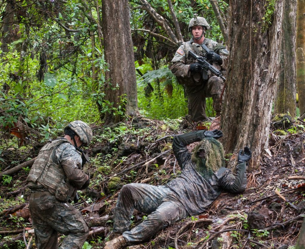 U.S. Army Spc. Cruser Barnes (top), 1st Squadron, 299th Cavalry Regiment, Hawaii Army National Guard (HIARNG), and Sgt. Shaun Gomes, 227th Brigade Engineer Battalion, HIARNG, secure and search a simulated aggressor during the Region VII Best Warrior Competition (BWC) May 5, 2015, at the Keaukaha Military Reservation, Hawaii. Guardsmen from Arizona, California, Colorado, Guam, Nevada, New Mexico, Utah and Hawaii competed during the competition for the chance to compete in the Army National Guard BWC later this year.