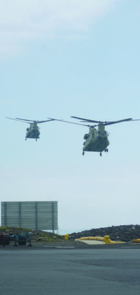 A pair of Hawaii Army National Guard CH47 Helicopters assigned to Company B, 1st Battalion, 171st Aviation Regiment approach Honolulu Harbor Pier #1. March 16, 2018. (U.S. National Guard Photo by Tech. Sgt. Andrew Jackson)