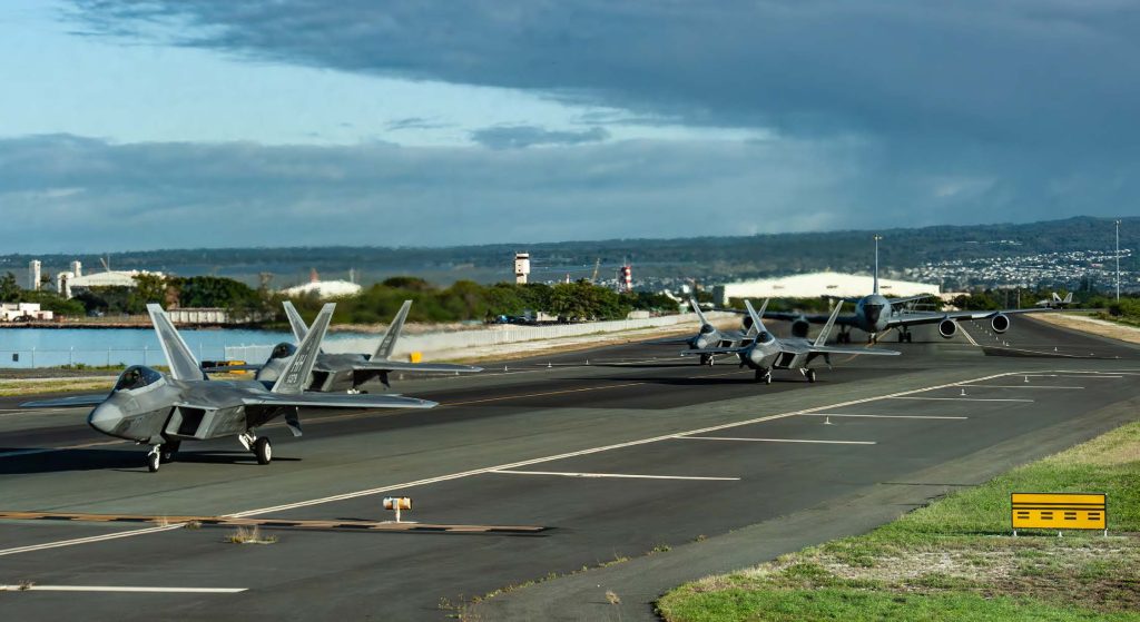 U.S. Air Force F-22A Raptors assigned to the 199th Fighter Squadron, operated by members of the 199th and 19th Fighter Squadrons, and a KC-135 Stratotanker assigned to the 203rd Air Refueling Squadron taxi the runway at Joint Base Pearl Harbor-Hickam, Hawaii, on Feb 5, 2025 for Sentry Aloha 25-1. Fighter jets, tankers, and support units participated in simulated combat scenarios, enhancing interoperability and readiness among U.S. military forces. (U.S. Air National Guard photo by Senior Airman Roann Gatdula)