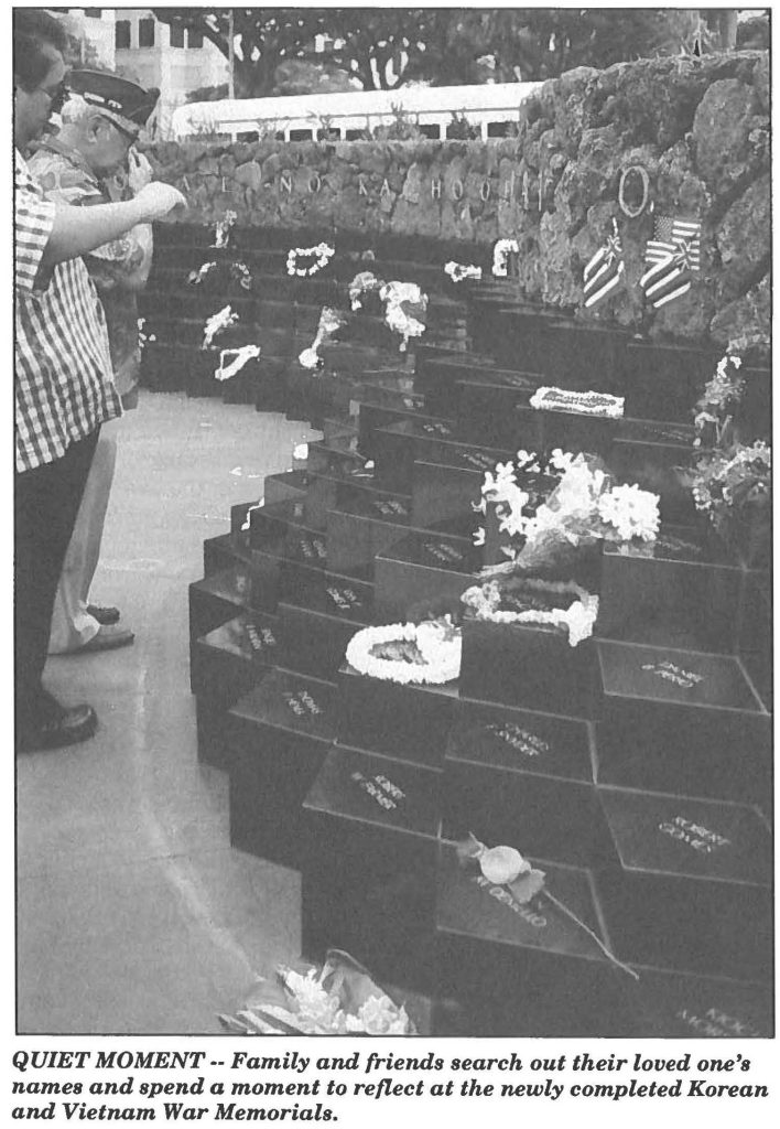 QUIET MOMENT -- Family and friends search out their loved one's names and spend a moment to reflect at the newly completed Korean and Vietnam War Memorials.