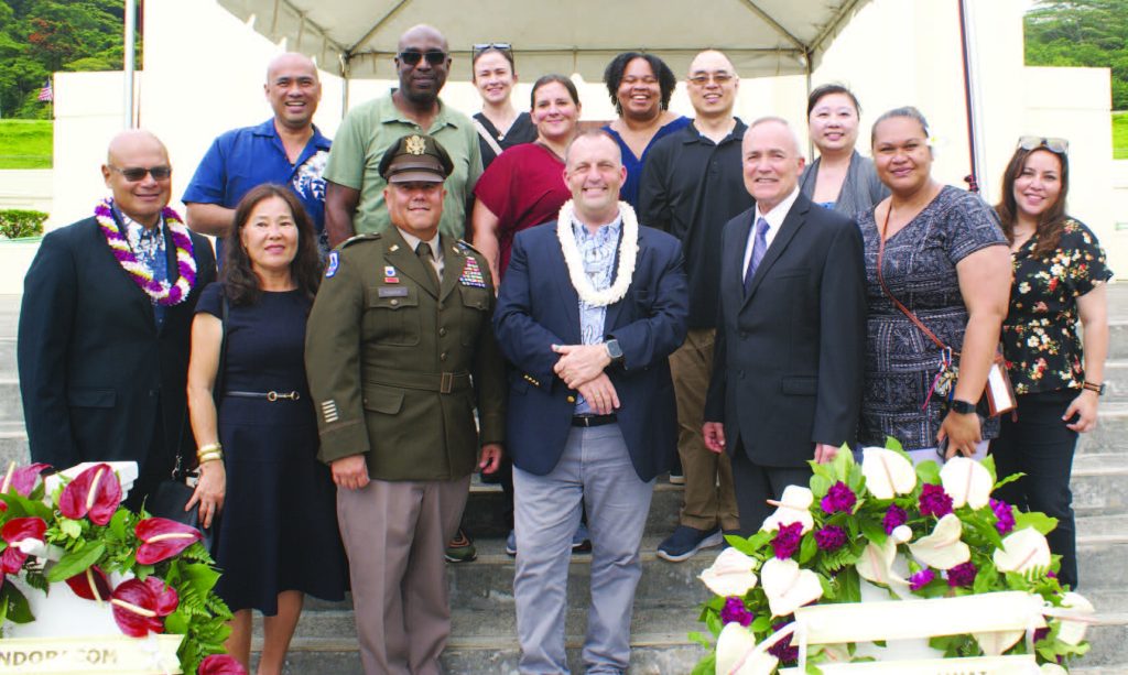 Officials and staff from the Office of Veterans’ Services attend the Memorial Day ceremony on May 27, 2024. Front row: OVS Director John Alamodin, left, Mrs. Myoung Hara, Maj. Gen. Kenneth S. Hara, Gov. Josh Green M.D., Interim OVS Director Brig. Gen. (Ret) Bruce Oliveira, Melegalenuu Sene-Whitehead and Kimberly Magday. Back row: Lawrence Ilustre, left, Eric Chapman, Carolyn Visoria, Andrea Barringer, Yolanda Ehere, Jonathan Kimura and Yam Yi Lee. – Jayme Nagamine photo