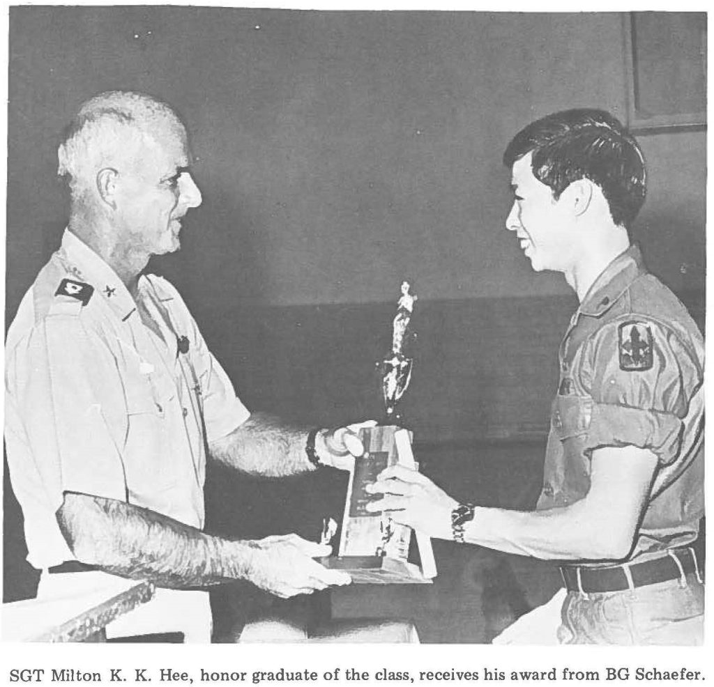 SGT Milton K. K. Hee, honor graduate of the class, receives his award from BG Schaefer.