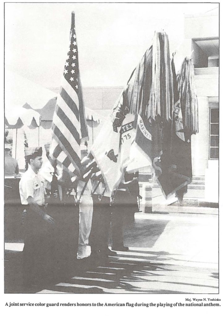 A joint service color guard renders honors to the American flag during the playing of the national anthem.