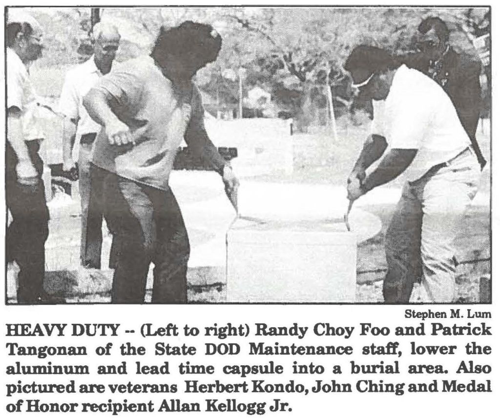 HEAVY DUTY -- (Left to right) Randy Choy Foo and Patrick Tangonan of the State DOD Maintenance staff, lower the aluminum and lead time capsule into a burial area. Also pictured are veterans Herbert Kondo, John Ching and Medal of Honor recipient Allan Kellogg Jr.